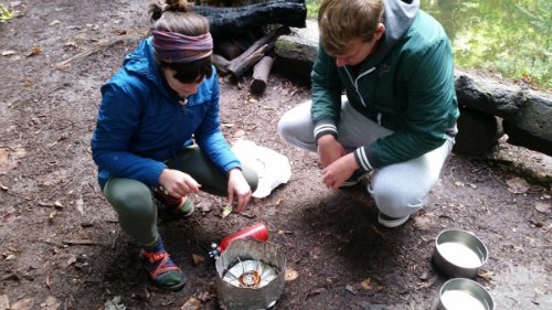 People around a camping stove