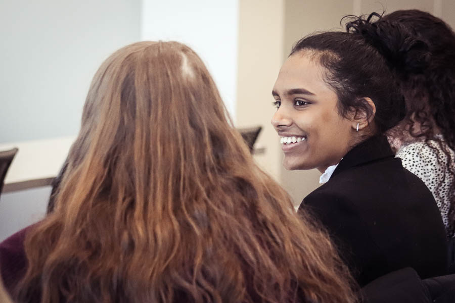 a student smiles at a conference at uwgb