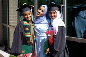 Three female students in hijabs graduate