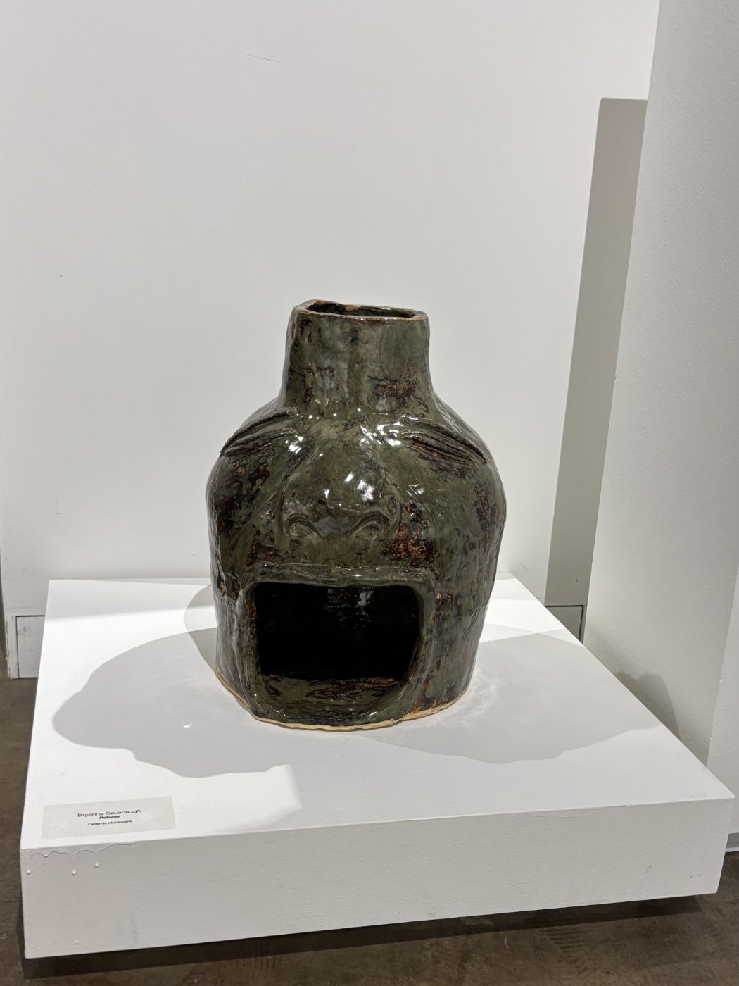 Small, moss green ceramic pot.