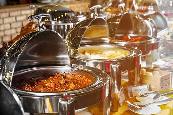 silver catering dishes set up in a buffet style