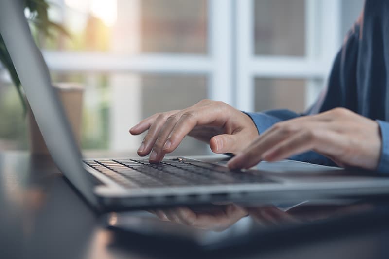 provider hands typing on laptop keyboard