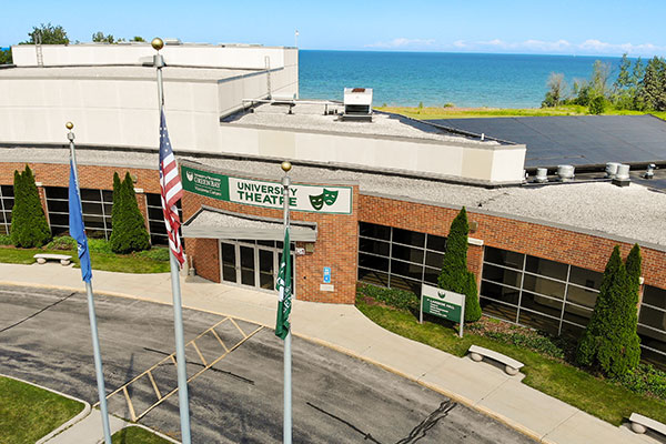 The front entrance to the Manitowoc campus with Lake Michigan in the background.