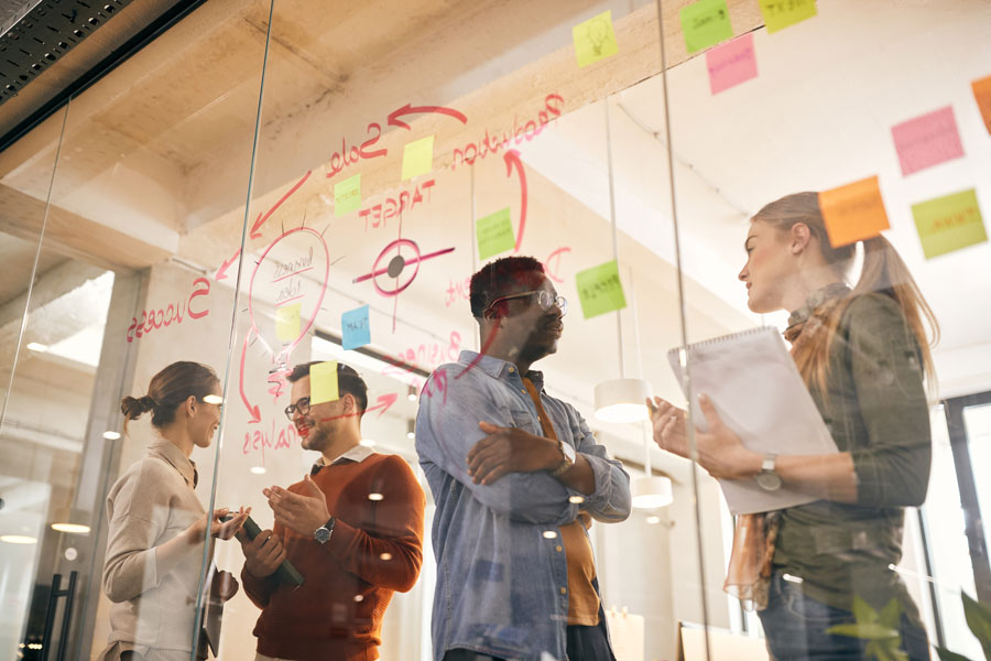 Group of coworkers using post it notes for discussion