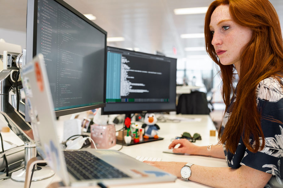 Woman in office working on computer programming