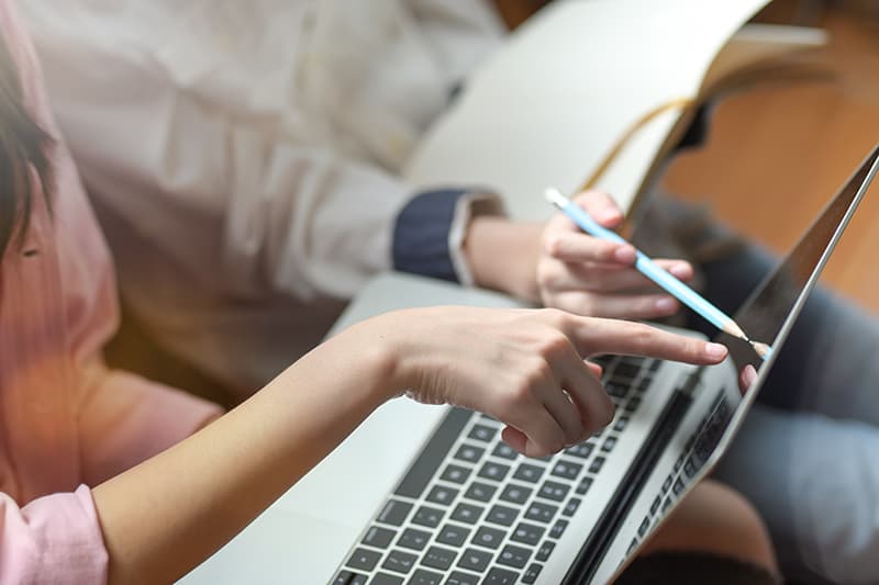 Student browsing website with their parent