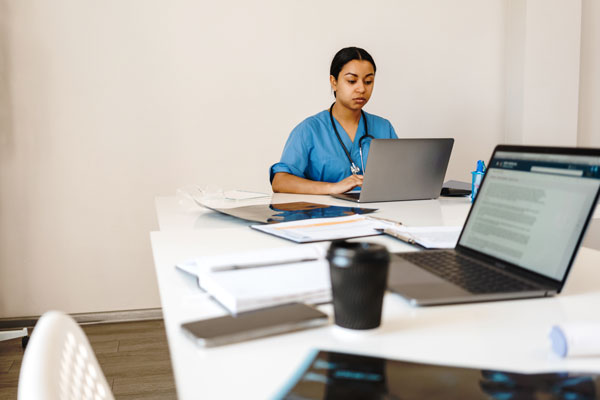 Female at table working on laptop