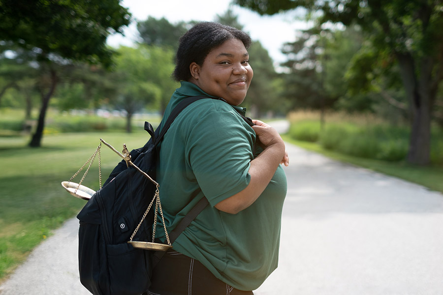 Student with Scale of Justice in her backpack