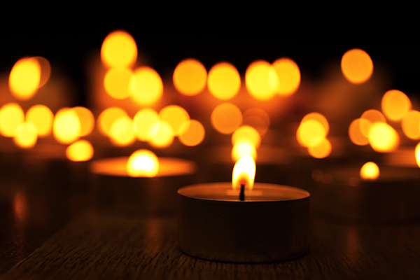 tealight candles glowing on dark background