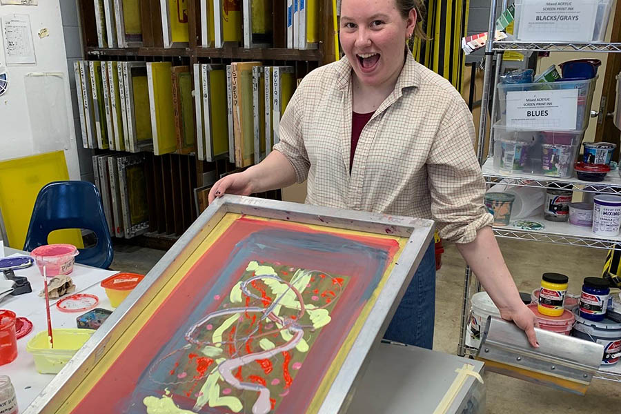 Happy student with printmaking art