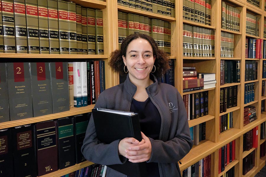 Pre-law student in front of bookcase