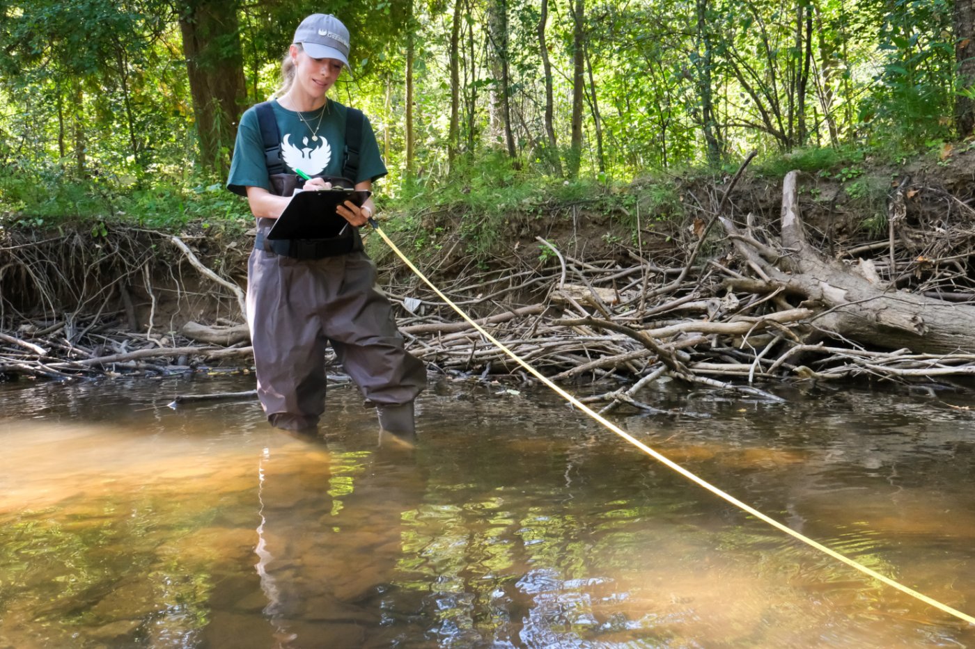 Jessie Kreiling surveying a creek