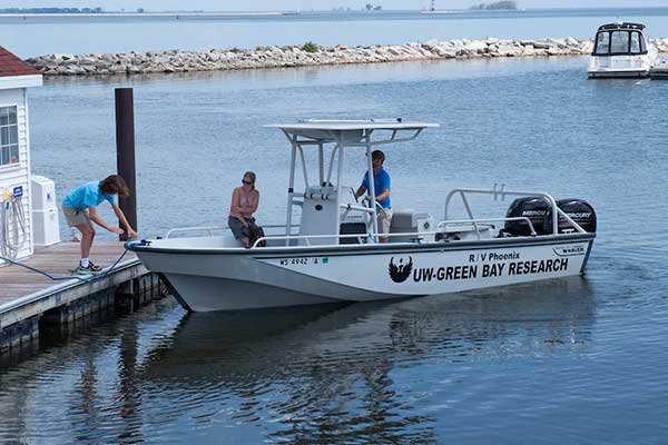Students on boat set out for water testing.