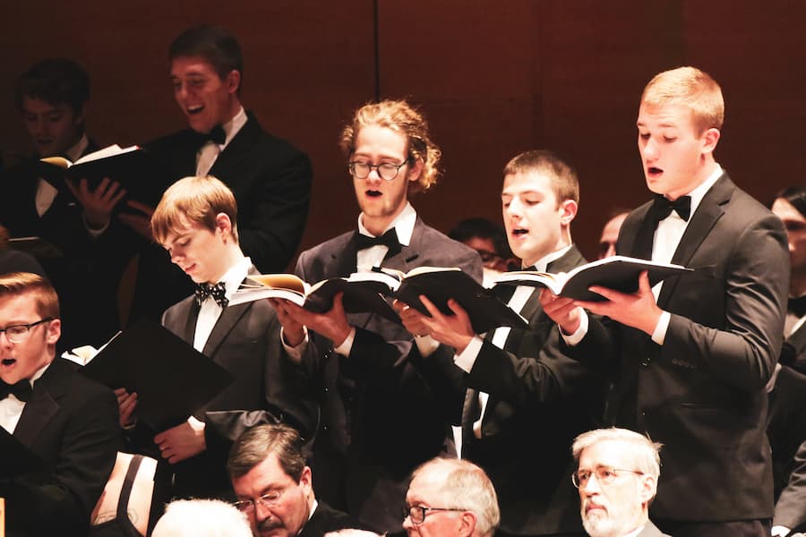 Vocal students singing in a concert choir performance