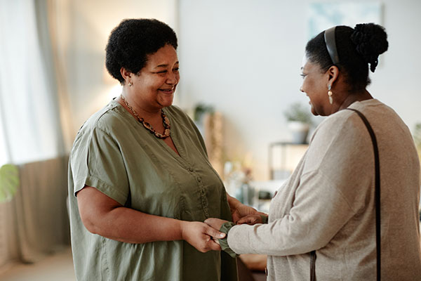 side view of senior woman welcoming guest