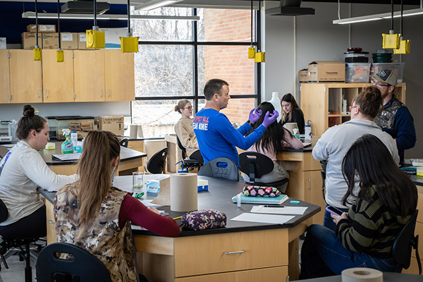Professor and students in lab classroom