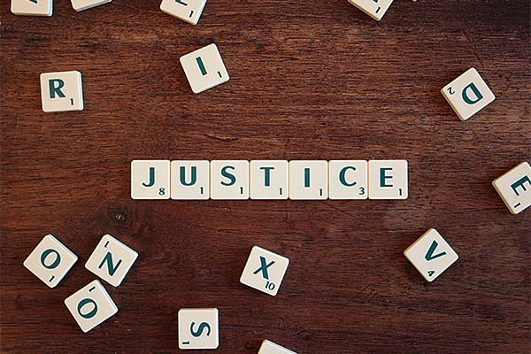 'Justice' spelt out with Scrabble tiles