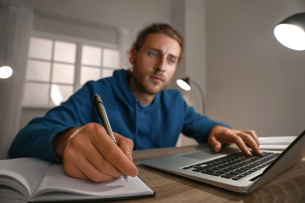 Male student studies at computer