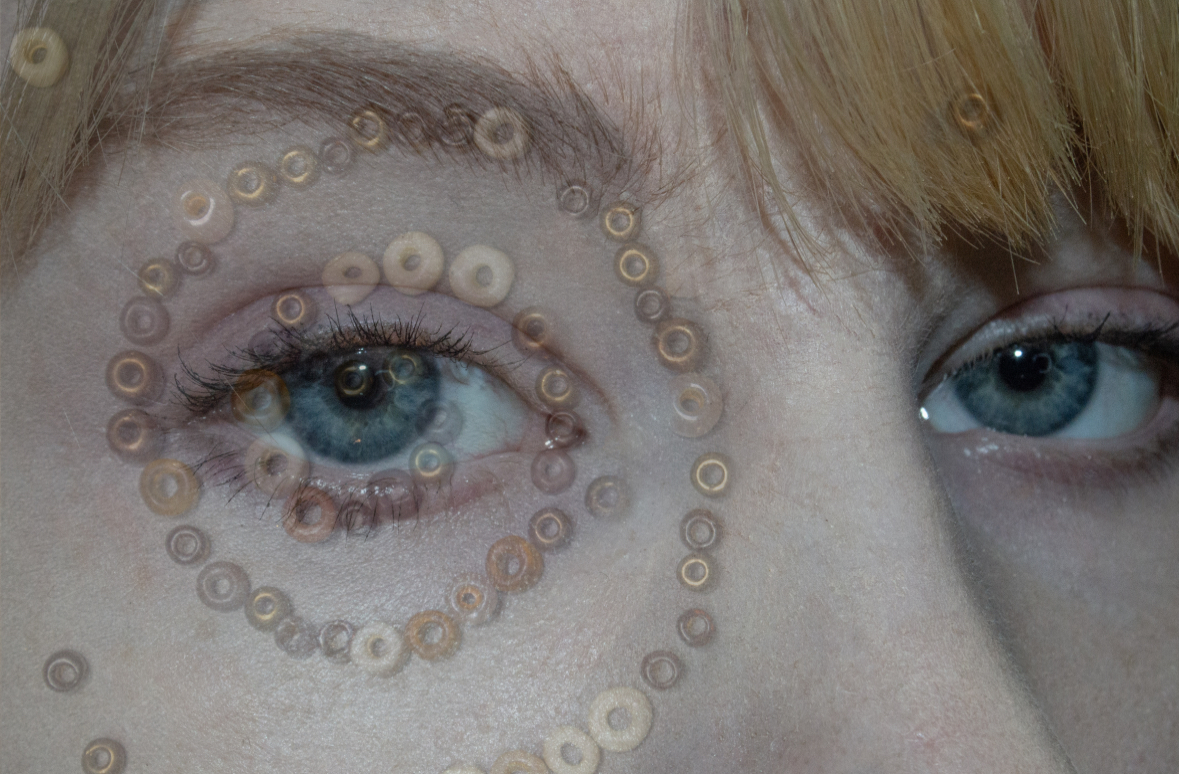 Photo of a person's eyes, with a swirl of sequins around one eye.