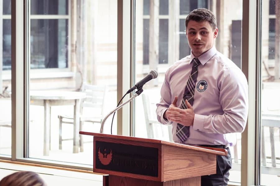 Male student gives speech at strategic philanthropy event