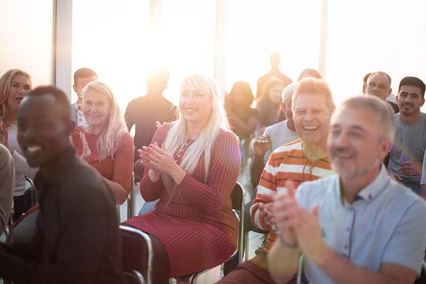 smiling audience applauding speaker