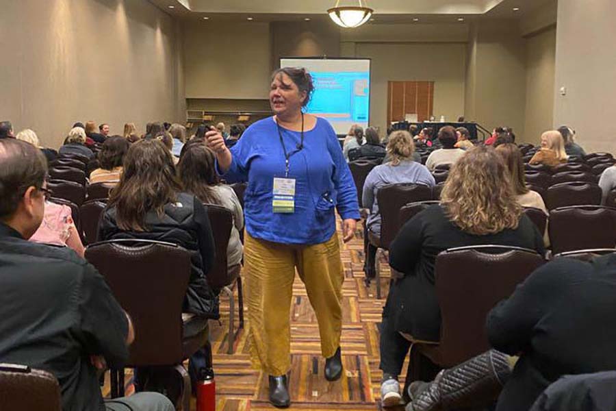 presenter walking through aisle during session