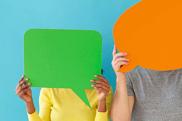 woman holding green speech bubble up