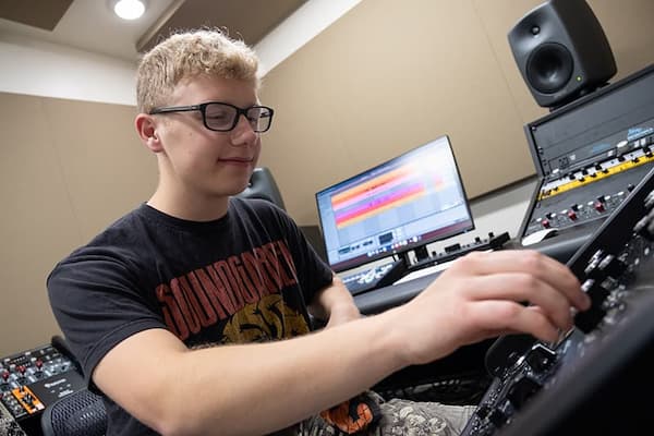 Student working at sound board