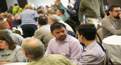 student and faculty converse