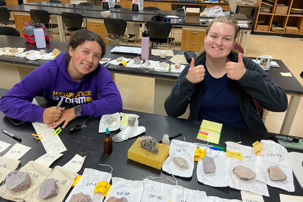 Students give a thumbs up in geoscience lab