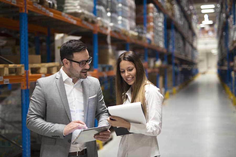 Head manager and collegue walk through business warhouse