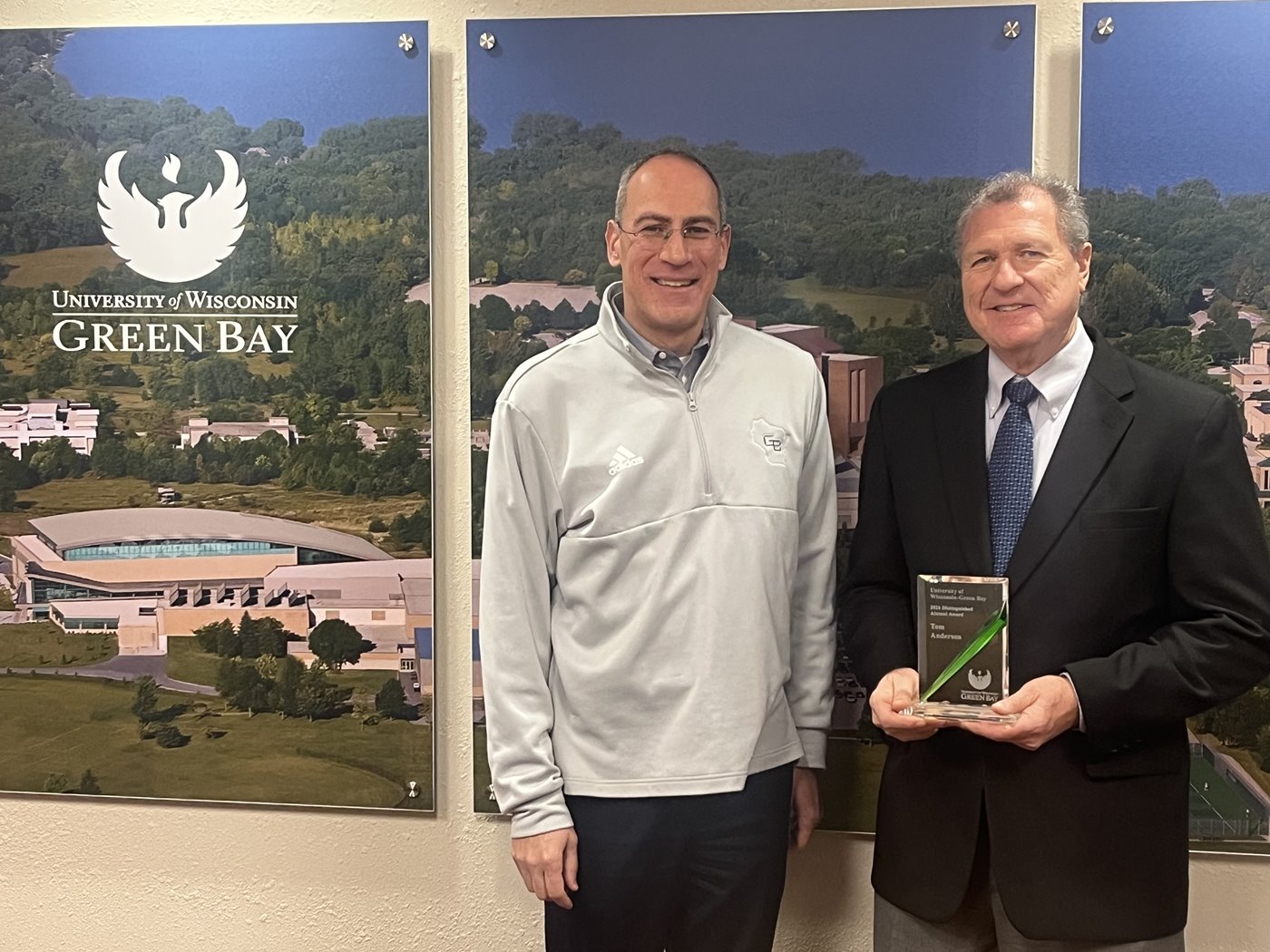 Tom Anderson receiving the 2026 Distinguished Alumni Award from Chancellor Michael Alexander