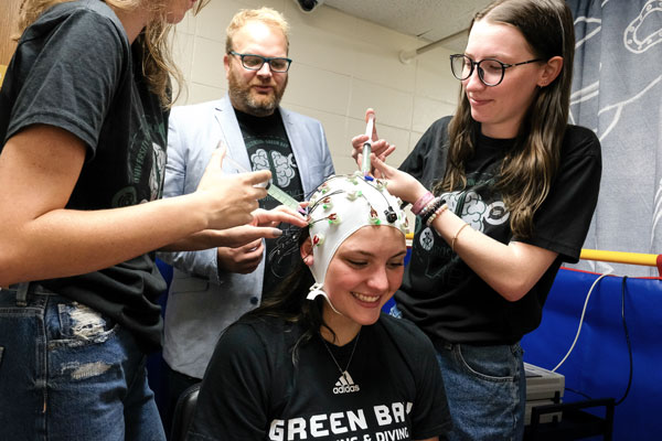 Professor trains research students on setting up the electroencephalographic cap