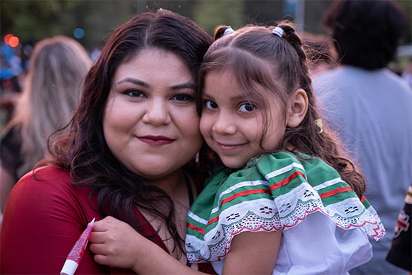 Latina woman and young girl at the 2023 Estamos Aquí festival at UW-Green Bay