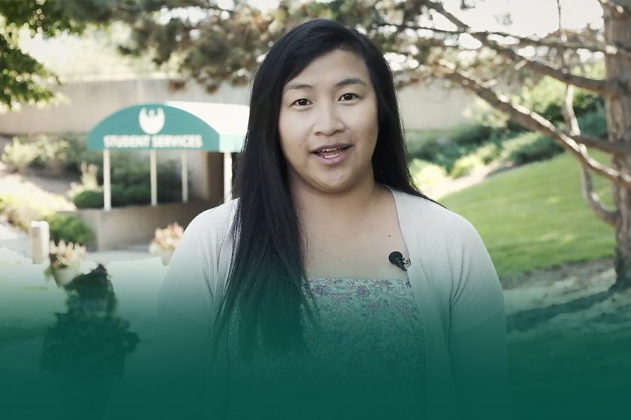 Video still of student speaking in front of a campus building