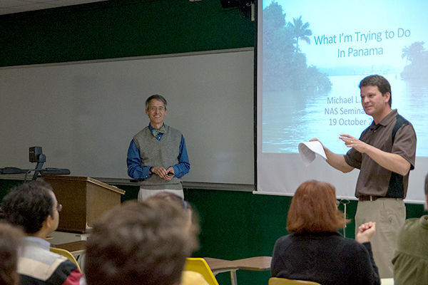 Presenters in front of room at a seminar