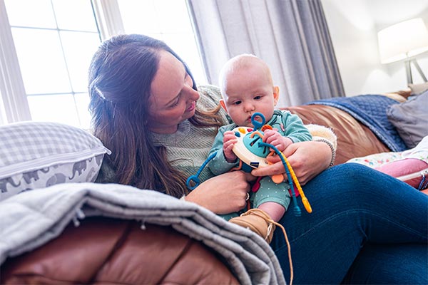 UWGB MSN student Lauren Wooten at home with her baby.