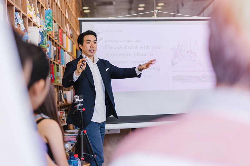 man presenting to work team