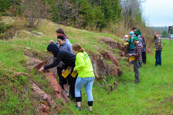 Students studying geoscience outdoors