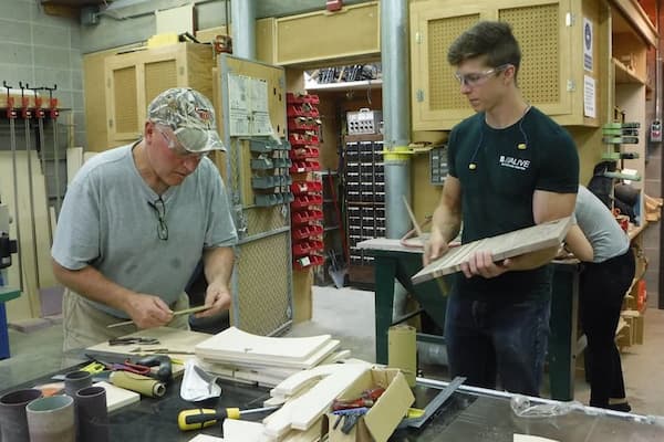 Professor helps student with project during studio