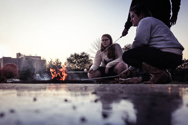 Students roasting marshmallows at the UWGB Campus Fire Pit Dedication