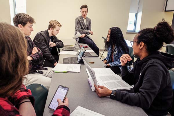 Students in class discussion with professor