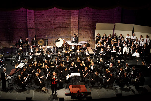 Wind ensemble and singers on stage
