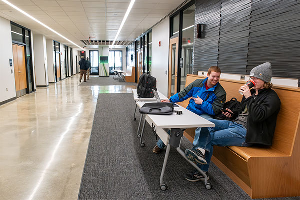 Two Electrical Engineering students study before class in the Dahlin Family Community Collaboration Space