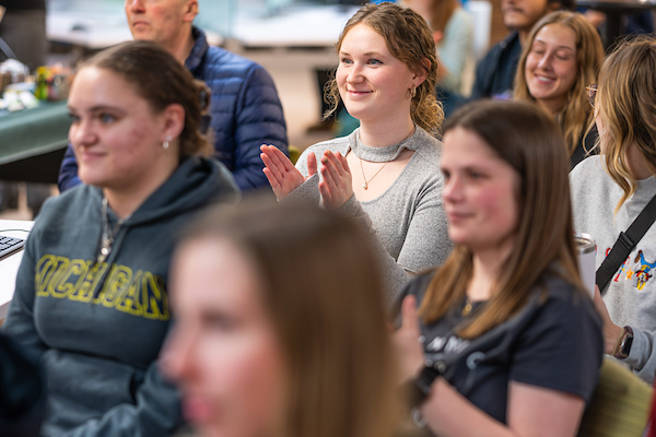 A crowd applauds at the Center for First Nations Education Collection celebration