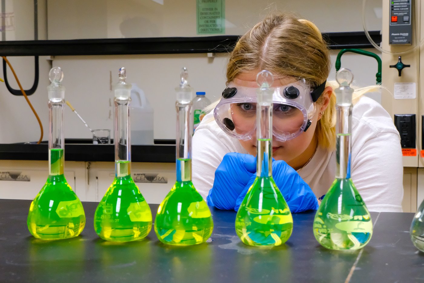 Chemistry student with beakers