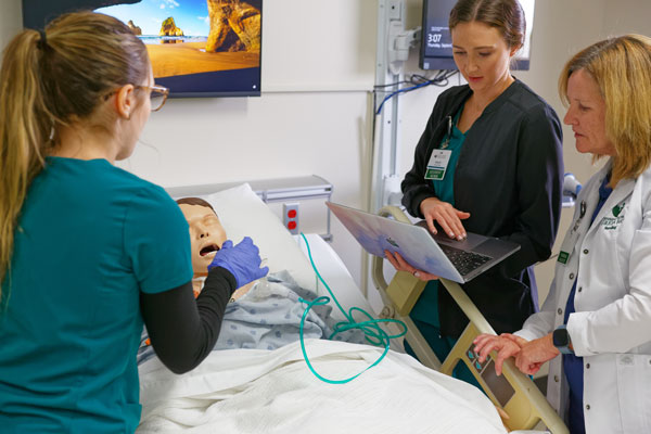 Student and professor practice on mannequin