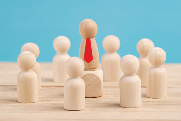 Wooden figures in a circle with one in the middle