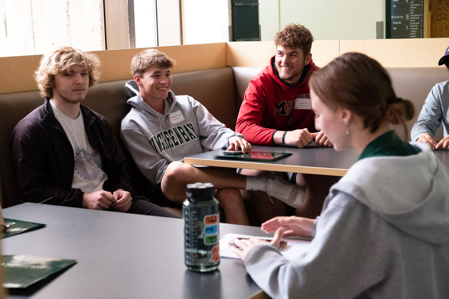 Group of students sit together in dining hall
