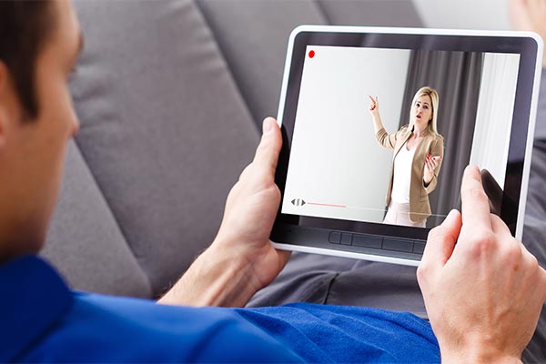 Student watching a lecture on tablet